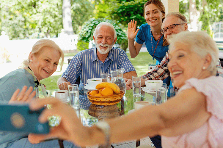 Compassionate Care Senior Living Group of older adults taking a selfie