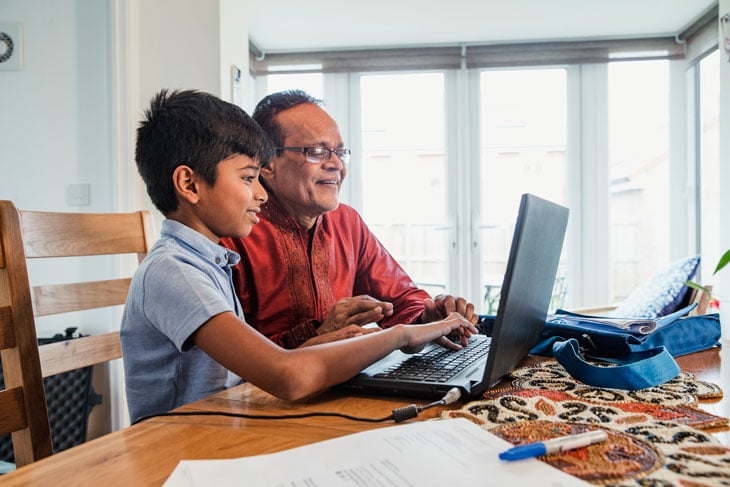 Grandchild-teaching-grandparent-technology