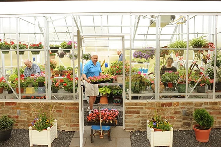 Senior residents working in a senior living greenhouse