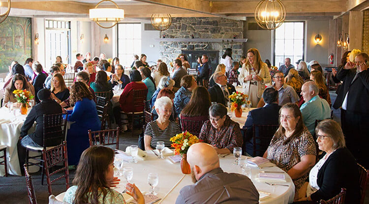 People sitting at tables in formal restaurant dining room