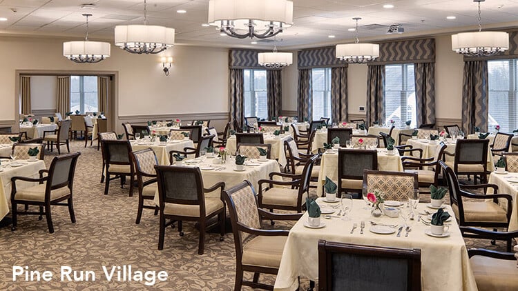 Formal Senior Living Dining Experience with tables with nice tablecloths and padded chairs