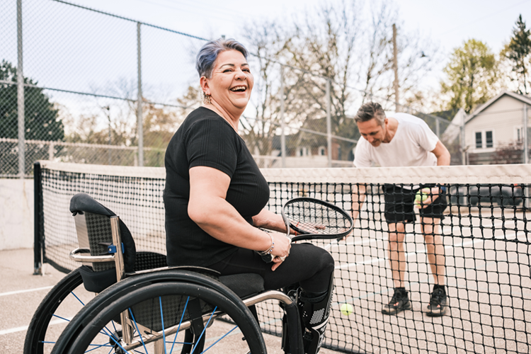 Woman in a wheelchair playing tennis