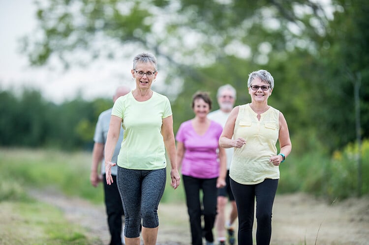 Group of senior women and men walking outdoors